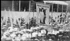 Newspaper photo showing "From Prison to Citizenship" banner in Coronation Procession