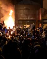 Community Members celebrating outside the burning 3rd precinct in Minneapolis, 2020