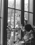 People in wheelchairs inside a building looking out of a glass door, where a man with a wheelchair looks in.