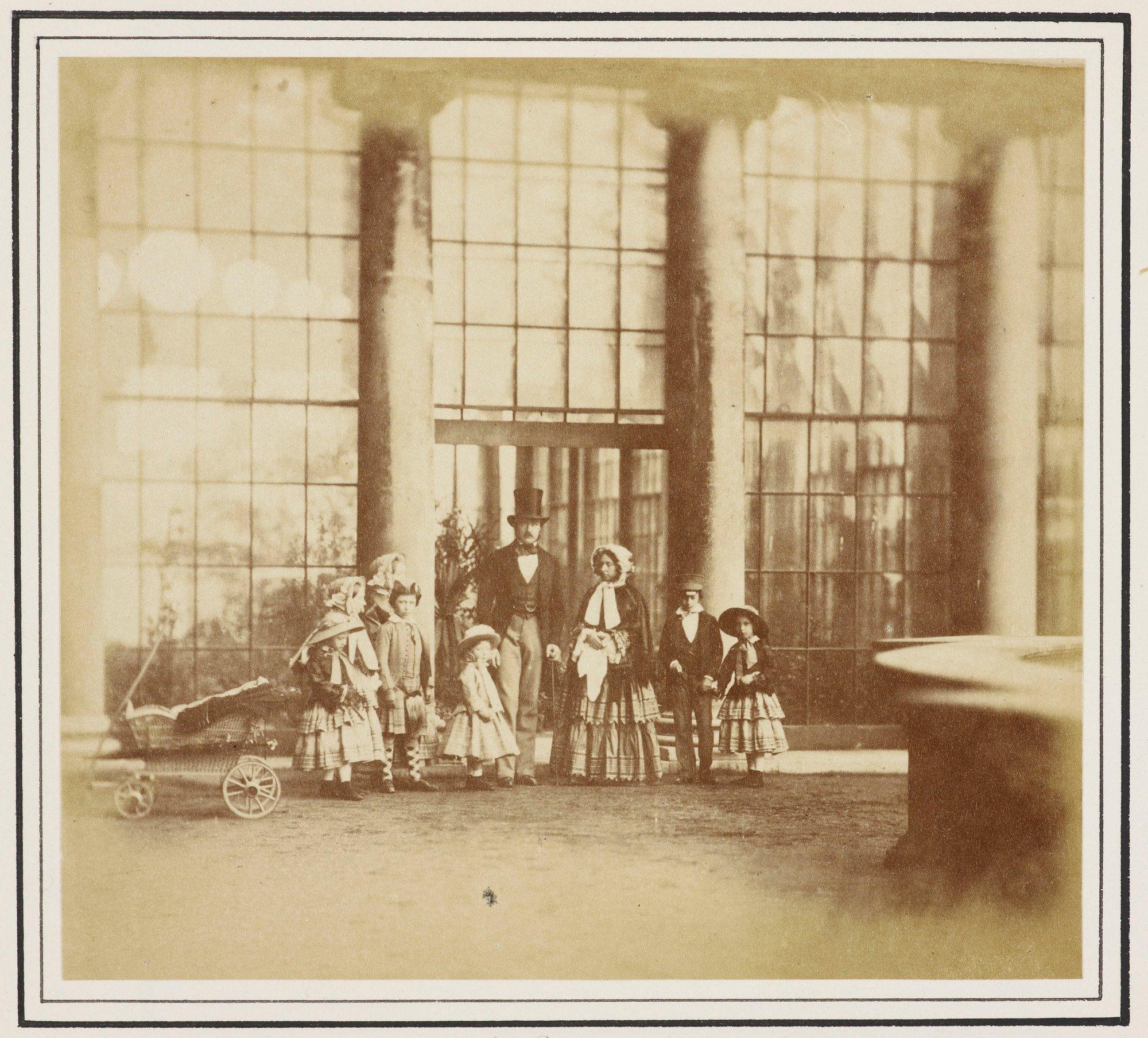 Photograph of Queen Victoria (1819-1901) and Prince Albert (1819-61) with seven of their children, posed outside Buckingham Palace.