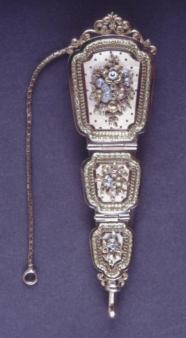 An ornate French chatelaine engraved with flowers